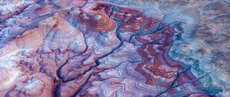 Aerial Abstract of the Bentonite Hills, Utah From above, the Bentonite Hills of Utah resemble a natural painting — swirling layers of lavender, rose, and slate blue sculpted by time and erosion. This...