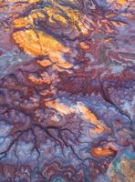 Sunset Light Over the Bentonite Hills, Utah — Aerial Desert Colors An aerial photograph of the Bentonite Hills near Capitol Reef National Park, Utah, glowing under the last rays of sunset light. The swirling layers of bentonite...