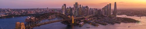 Aerial Panorama of Sydney Harbour Bridge, Opera House and Crown Sydney at Sunset A sweeping panoramic aerial view of Sydney Harbour at sunset, featuring the majestic Harbour Bridge, the world-famous Opera House, and the gleaming towers of...