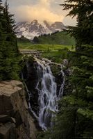 Myrtle Falls at Dusk – Mount Rainier National Park Soft evening light glows over Myrtle Falls and Mount Rainier as twilight settles across the Paradise meadows. The cascading waterfall tumbles through alpine...