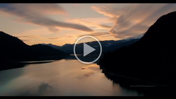 Mount Baker Sunset Lake Aerial Video Stunning 4K aerial footage of Mount Baker glowing in golden light above the calm waters of Baker Lake. Clouds drift through the North Cascades as the setting...