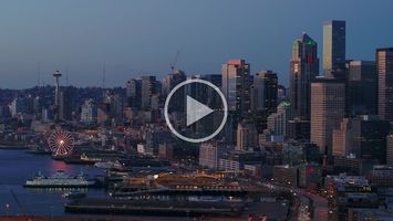 Aerial Downtown Seattle Blue Hour Skyline ProRes422 A breathtaking aerial video of downtown Seattle filmed during the magical blue hour, when the city glows with twilight hues and shimmering reflections across...