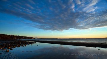 Discovery Park Tidepools A quiet evening settles over Discovery Park Beach as soft clouds reflect across the still tidal pools along Puget Sound. Gentle light from the setting sun...