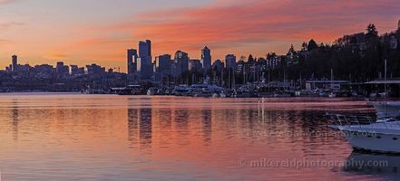Morning on Lake Union Wide panoramic view of the Seattle skyline reflected on Lake Union in the soft morning light, with the Space Needle and downtown buildings glowing beneath a...