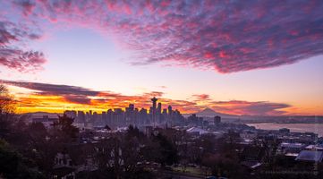 Seattle Kerry Park Photography Sunrise Colors Curve Brilliant morning light fans across the sky above Seattle in this stunning sunrise view from Kerry Park. The Space Needle and Mount Rainier rise beneath...