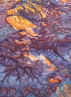Sunset Light Over the Bentonite Hills, Utah — Aerial Desert Colors An aerial photograph of the Bentonite Hills near Capitol Reef National Park, Utah, glowing under the last rays of sunset light. The swirling layers of bentonite...
