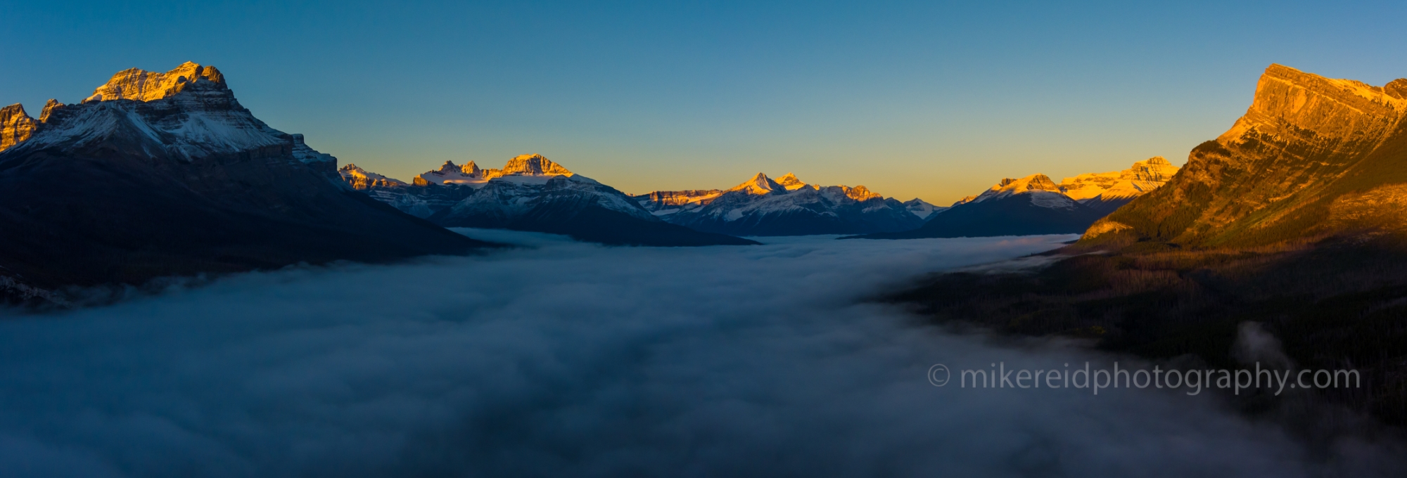 Over the Canadian Rockies Peaks Above the Clouds Sunrise Pano