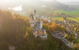 Aerial Castle Neuschwanstein Sunlit Fall Colors.jpg default