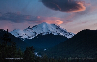 Mount Rainier Lenticular Cloud Sunset Over the White River A breathtaking sunset over Mount Rainier paints the sky with pink and violet tones as lenticular clouds crown the snow-covered summit. Below, the White River...