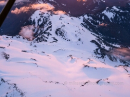 Over the North Cascades Mount Baker Coleman Glacier An aerial photograph capturing the glowing expanse of Mount Baker’s Coleman Glacier as sunset bathes the mountain in soft pink and violet light. The winding...