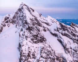 Over the North Cascades Mount Baker Colfax and Black Buttes A breathtaking aerial close-up of Mount Baker’s rugged Black Buttes and Colfax Peak rising above a sea of snow and ice in the North Cascades. Captured with the...