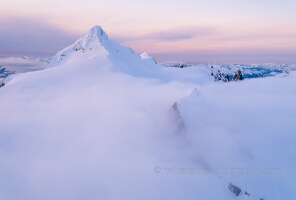 Over the North Cascades Mount Shuksan in the Clouds Soft morning mist drapes the Crystal and Sulphide Glaciers on Mount Shuksan, their flowing ice barely visible beneath a sea of clouds. Rising through the haze,...