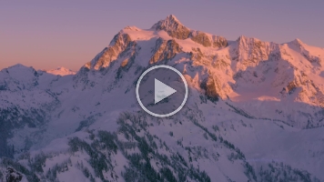 Mount Shuksan and Artists Point Snowscape Alpenglow Video.mp4 Magnificent 4K aerial footage of Mount Shuksan glowing in brilliant alpenglow at sunset above the snow-covered peaks of the North Cascades. The fading light...