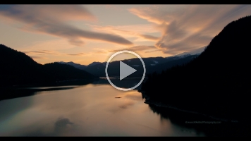 Mount Baker Sunset Lake Aerial Video Stunning 4K aerial footage of Mount Baker glowing in golden light above the calm waters of Baker Lake. Clouds drift through the North Cascades as the setting...