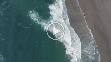 Over Cannon Beach Morning Light and Waves Video.mp4 Stunning 4K aerial footage of Cannon Beach and the iconic Haystack Rock, captured from above as surf waves roll gently onto Oregon’s rugged coast. The morning...