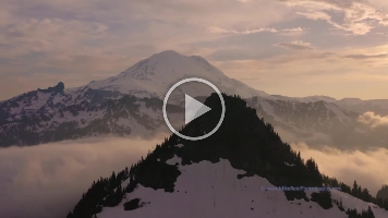 Over the Northwest Rainier Fog Drone Video.mp4 Immersive 4K drone footage over Chinook Pass and Mount Rainier, where morning fog drifts through the valleys beneath snow-covered ridges. The golden light of...