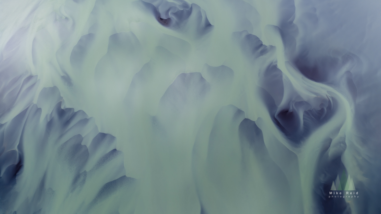 Soft Iceland ice patterns in pale blue tones with flowing shapes