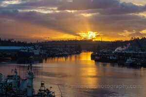 Seattle Ship Canal Sunrise Sunrays Golden sunrise over Seattle’s Lake Washington Ship Canal with fishing vessels and the Fremont Bridge silhouetted against radiant morning light and clouds.