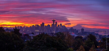 Seattle Kerry Park Burning Sunrise Panorama GFX50s A gorgeous fiery sunrise over Seattle captured from Kerry Park, where vivid shades of crimson, magenta, and gold ignite the morning sky. Lenticular clouds swirl...