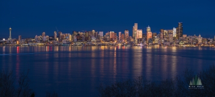 Seattle Blue Hour Panorama From Hamilton GF63mm Panoramic Seattle skyline at blue hour viewed from West Seattle, with the Space Needle and downtown buildings glowing above Elliott Bay and their reflections...