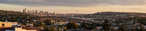 Seattle and Interstate Bridge from the University District Warm evening light washes over Seattle as traffic flows across the Interstate 5 bridge, leading the eye toward the downtown skyline and iconic Space Needle...