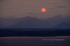Olympic Mountains Red Sun Setting To order a print please email me at  Mike Reid Photography : seattle, sky view observatory, svo, zeiss lenses, columbia center, urban, sunrise, fog, sunset, puget sound, elliott bay, space needle, northwest, washington, rainier, olympicsolympic mountains