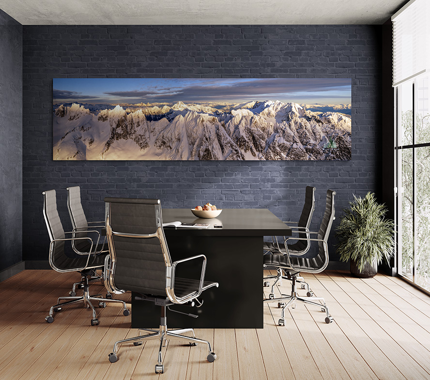 Large mountain landscape photograph in a modern meeting room