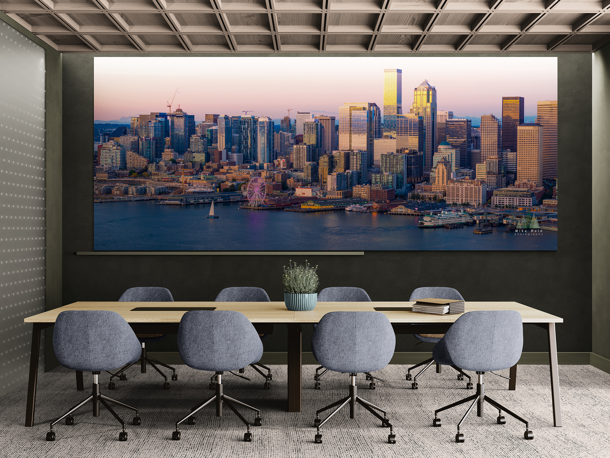 Seattle waterfront sunset photograph displayed in a conference room