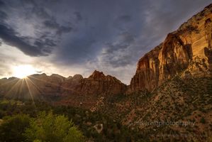 Sunset Sunstar Over Zion Canyon — Zion National Park, Utah The setting sun bursts through the rugged cliffs of Zion National Park, casting a radiant sunstar across the canyon as storm clouds drift above the glowing...