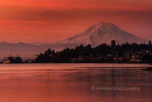 Tacoma Sunset with Mount Rainier from Point Defiance Park A brilliant sunset over Tacoma glows in deep shades of red and gold as Mount Rainier rises majestically beyond the city skyline. Captured from Point Defiance...