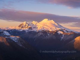 Over the North Cascades Mount Baker Dusk Warmth Bathed in soft alpenglow, Mount Baker and its striking neighbor Colfax Peak glow under the golden hues of sunrise in this serene alpine composition. Captured in...