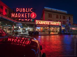 Pike Place Market Christmas Reflection Seattle’s Pike Place Market shines bright on a quiet winter evening, with its iconic red neon “Public Market” sign reflected perfectly in a nearby car hood. The...