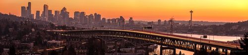 Seattle Golden Sunset Bridge UW Wide Pano.jpg A glowing Seattle sunset paints the sky orange and gold as streaks of headlights and taillights trace graceful lines across the Interstate 5 bridge. The Space...