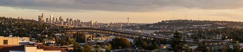 Seattle and Interstate Bridge from the University District Warm evening light washes over Seattle as traffic flows across the Interstate 5 bridge, leading the eye toward the downtown skyline and iconic Space Needle...
