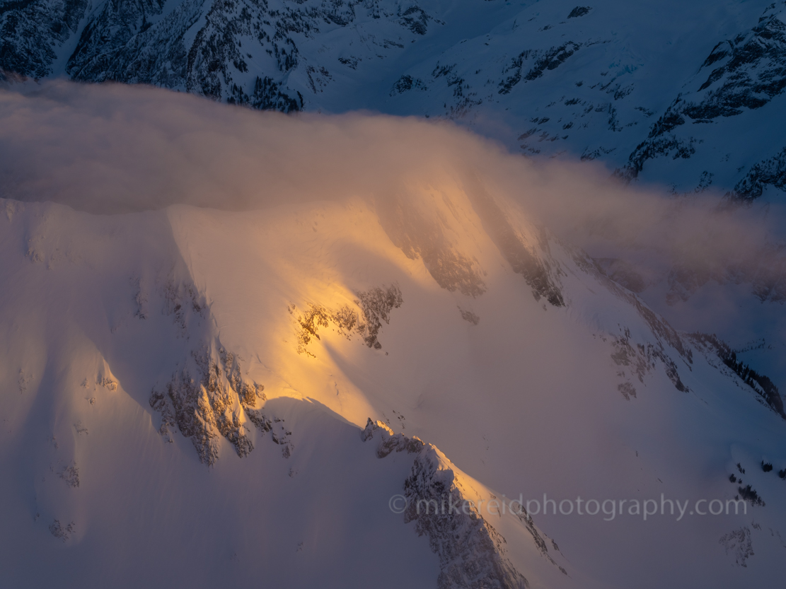 Alpine slopes through cloud