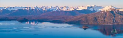 Over Alaska Petersburg Coast Range Pano Reflection An expansive panoramic view of Frederick Sound and the snow-capped Coast Range bathed in soft evening light. The tranquil waters mirror the rugged peaks and...