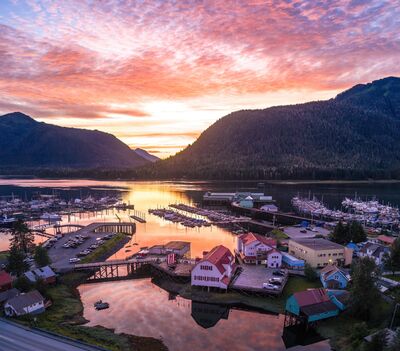 Sunset over Hammer Slough and Wrangell Narrows, Petersburg Alaska Golden light reflects off Hammer Slough and the calm waters of Wrangell Narrows in this sunset aerial view of Petersburg, Alaska. The historic Sons of Norway...