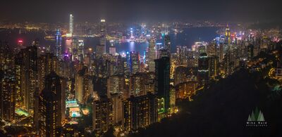 Hong Kong Skyline and Victoria Harbour Illuminated at Night Thousands of city lights illuminate Hong Kong Island and Victoria Harbour in this panoramic nighttime view from Victoria Peak. Towering skyscrapers glow in...