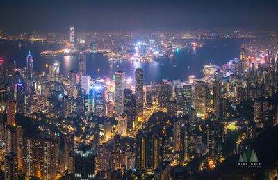 Hong Kong Victoria Harbour and Central Skyline at Night A sweeping nighttime view from Victoria Peak reveals the illuminated skyscrapers of Central Hong Kong, the expansive waters of Victoria Harbour, and the glowing...