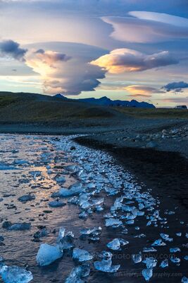 Lenticular Clouds and Ice Shoreline – Jökulsárlón Sunset, Iceland A dramatic sunset unfolds over Iceland’s Jökulsárlón Glacier Lagoon as lenticular clouds swirl above a shoreline strewn with crystal-blue ice. Each fragment...