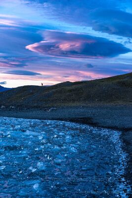 Iceland Jokulsarlon Sunset and Ice A dramatic sunset unfolds over Iceland’s Jökulsárlón Glacier Lagoon as lenticular clouds swirl above a shoreline strewn with crystal-blue ice. Each fragment...