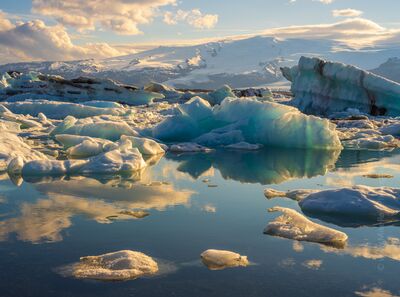 Evening Reflections at Jökulsárlón Glacier Lagoon – Iceland Icebergs in Golden Light Evening light shimmers across the glassy waters of Jökulsárlón Glacier Lagoon in Iceland, where turquoise icebergs drift beneath Vatnajökull Glacier. Captured...