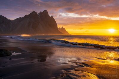 Stokksnes Golden Sunrise – Waves and Light Along Iceland’s Vestrahorn Coast A radiant sunrise floods the black sands of Stokksnes with golden light as waves crash beneath the shadow of Vestrahorn Mountain. This fine art photograph...