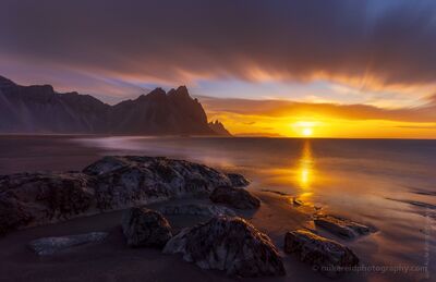 Stokksnes Sunrise – Vestrahorn Iceland Seascape | Sony A7R2 Fine Art Photography Golden sunrise light sweeps across the black sands of Stokksnes Beach in southeastern Iceland, illuminating the rugged Vestrahorn peaks and glistening...