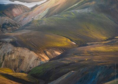 Iceland Ridge Hiking Landmannalaugar Highlands Zeiss 100-300mm GFX50s Golden light sweeps across the ridges of Iceland’s Landmannalaugar Highlands, illuminating layers of volcanic earth and moss-covered slopes. Captured with the...