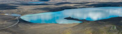 Þórisvatn Lake in the Iceland Highlands Aerial view of Þórisvatn in Iceland’s central Highlands, where striking blue water contrasts with the surrounding dark volcanic terrain. The broad, remote...