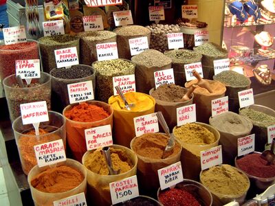 Colorful Turkish Spices at an Istanbul Bazaar An abundant display of colorful spices fills a market stall in Istanbul, Turkey. Open containers of saffron, paprika, cumin, cardamom, curry, and traditional...