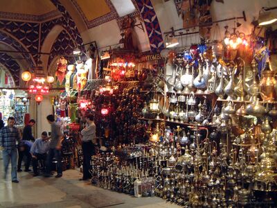 Grand Bazaar Brass Lanterns and Turkish Metalwork Istanbul Ornate brass and silver-colored vessels, traditional Turkish coffee pots, and colorful hanging glass lanterns fill a bustling passage inside Istanbul's historic...
