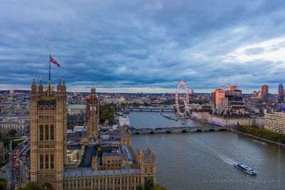 Westminster and the River Thames at Blue Hour A sweeping aerial-style view across central London at blue hour, with the Palace of Westminster and Victoria Tower rising beside the River Thames. The London...