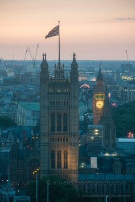 Big Ben and Victoria Tower at Dusk A telephoto evening view across Westminster, London, with Victoria Tower and the illuminated clock face of Big Ben rising above the surrounding city. The Union...